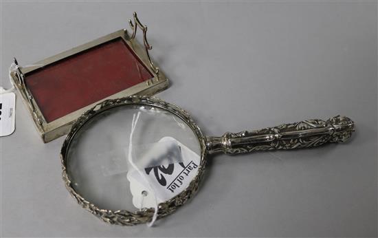 A silver-mounted magnifying glass, foliage, bird and mask-embossed (William Comyns) and a silver and leather-mounted pen stand